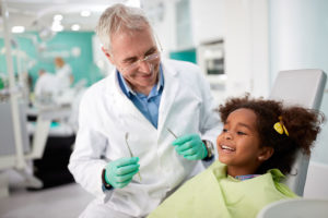 Orthodontist with happy child.